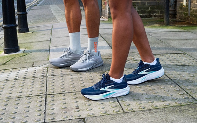 Close-up of two people’s feet wearing the Ghost 17 on the sidewalk