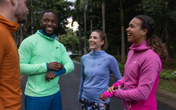 Two runners wear multiple layers and apparel to prepare for a winter run.
