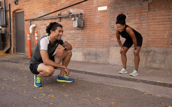 two runners crouching after a run