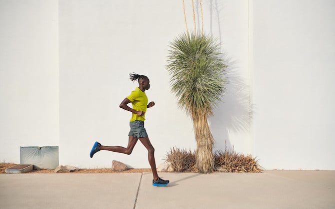 A runner with a white wall in the background.