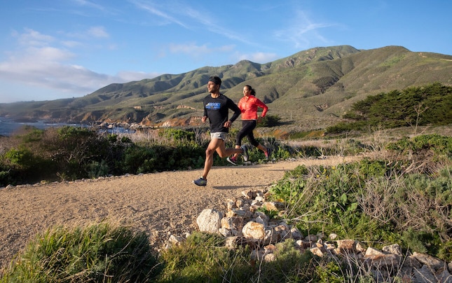 Two runners on dirt path