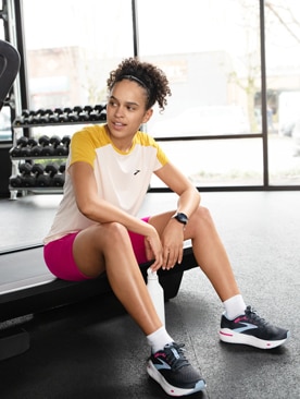 Woman sitting on a treadmill