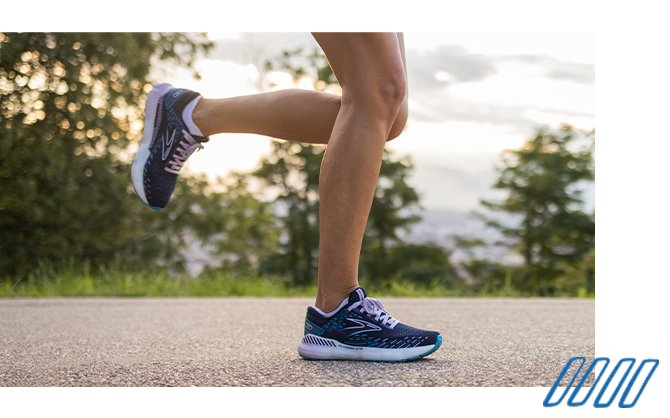 Close up photo of the legs of a runner wearing Brooks Adrenaline GTS shoes with GuideRails technology. 