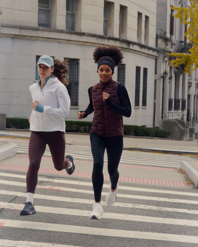 Two women running in Momentum Thermal apparel