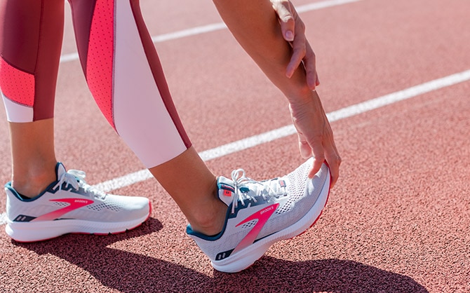 Woman stretching in method 7/8 tights.