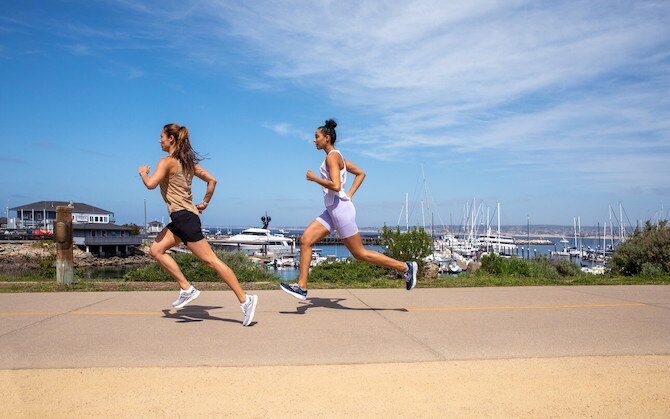 Two runners running outside during summer