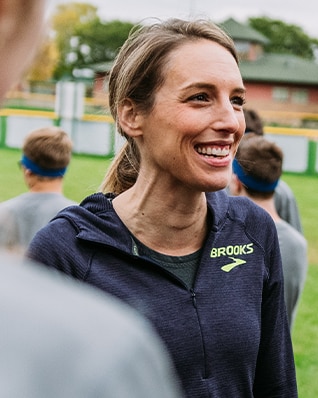 Gabe smiling while talking with a group of people