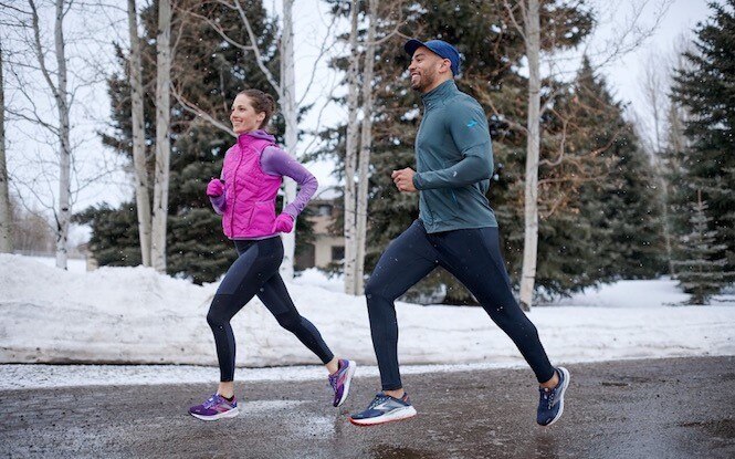 Two runners dressed in warm weather gear