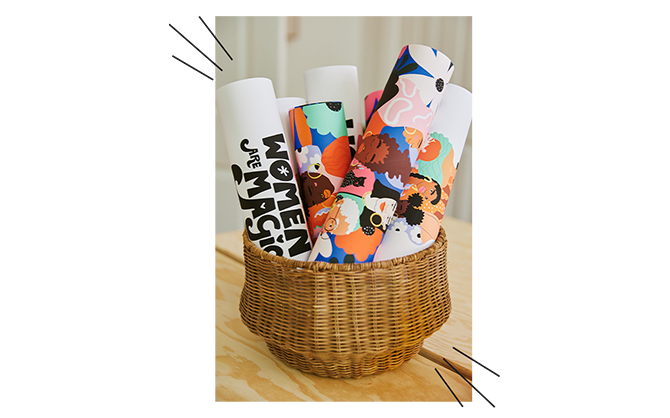 Basket with artwork rolled up in it