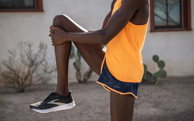 Runner pulling his knee to his chest as a stretch