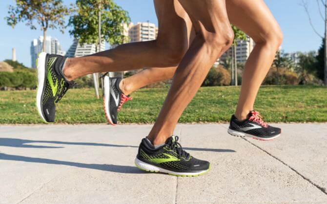 Runners are mid-stride wearing Brooks shoes with soft DNA LOFT cushioning