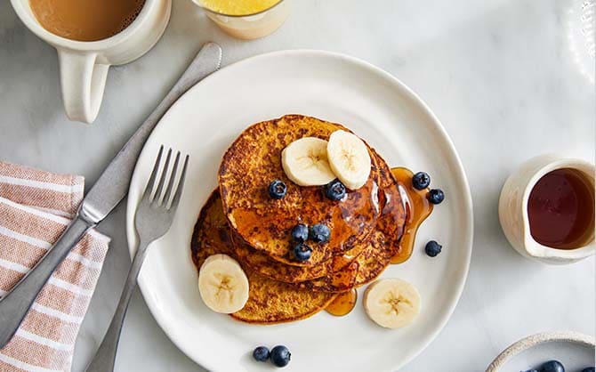 Pumpkin pancakes with blueberries and banana slices