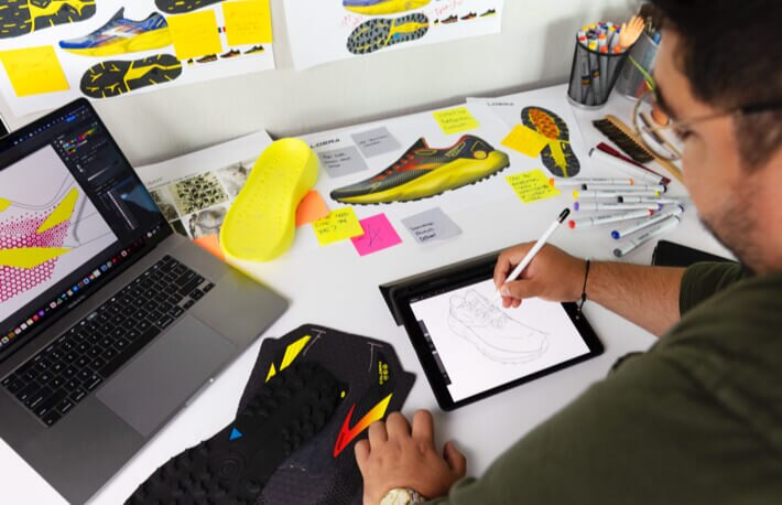 Man designing a trail running shoe on tablet