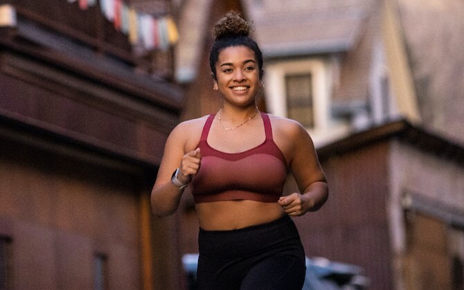 Women on a track with her feet in race blocks