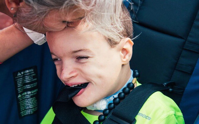 Rider-athlete, Benton, smiling with his mom