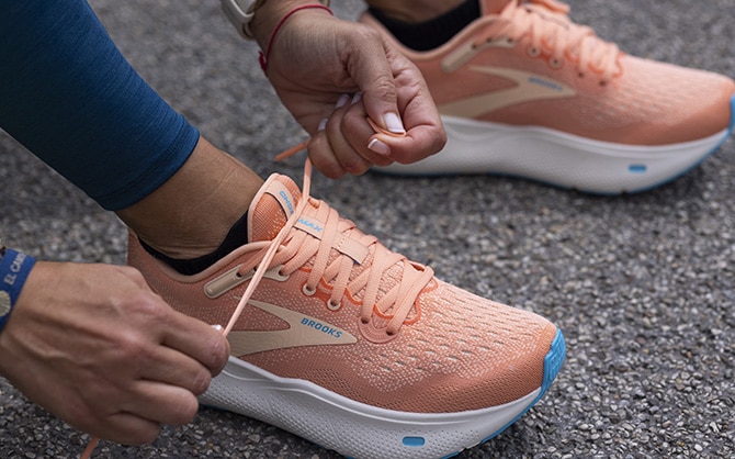 Runner lacing up their pair of Ghost Max
