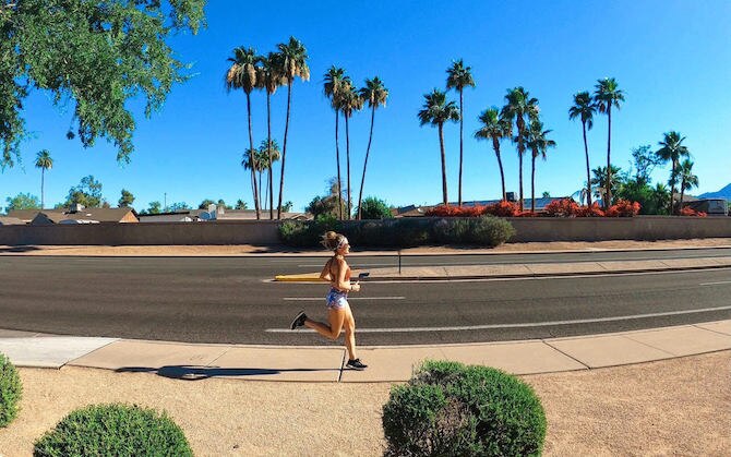 Runner with palm trees in the background