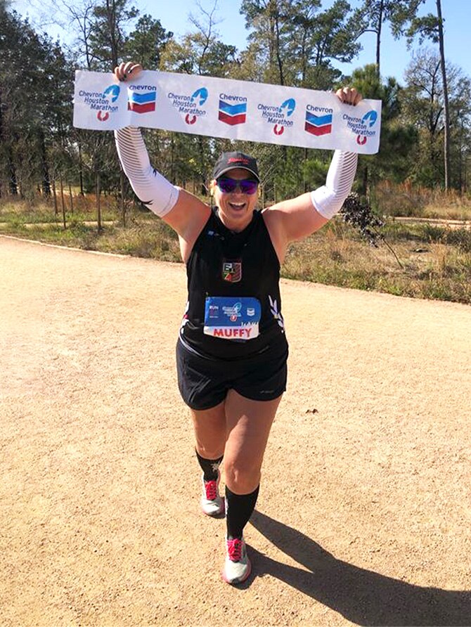 Runner holding up part of the finish line