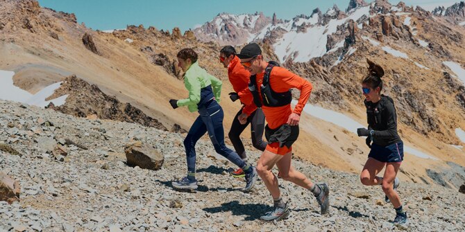 Group of trail runners running up a mountain