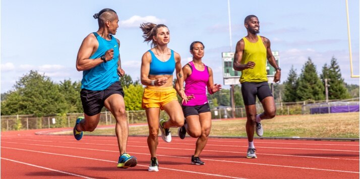 A group of runners on a track running side by side