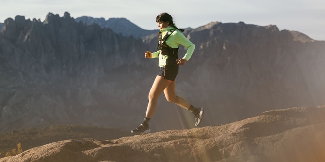 Trail runner up in the mountains while the sun is coming out