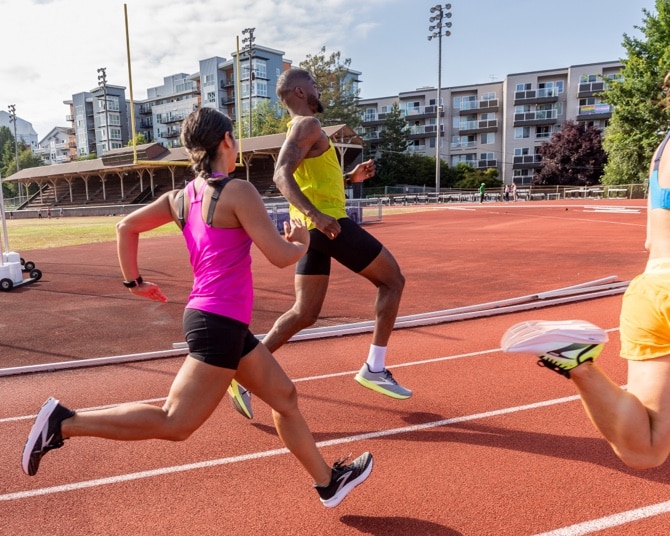 A group of runners on a track, sprinting