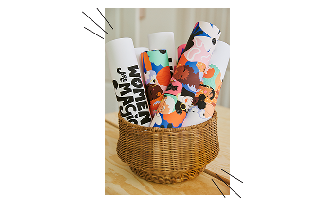 Basket with artwork rolled up in it