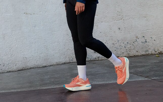 Image of woman walking in a pair of coral Ghost Maxs