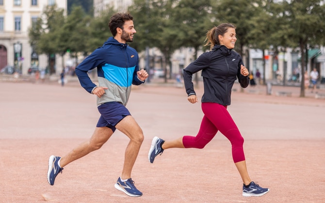 Woman runner in jogging outfit running on a street. Woman