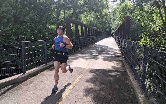 Matthew running over a bridge