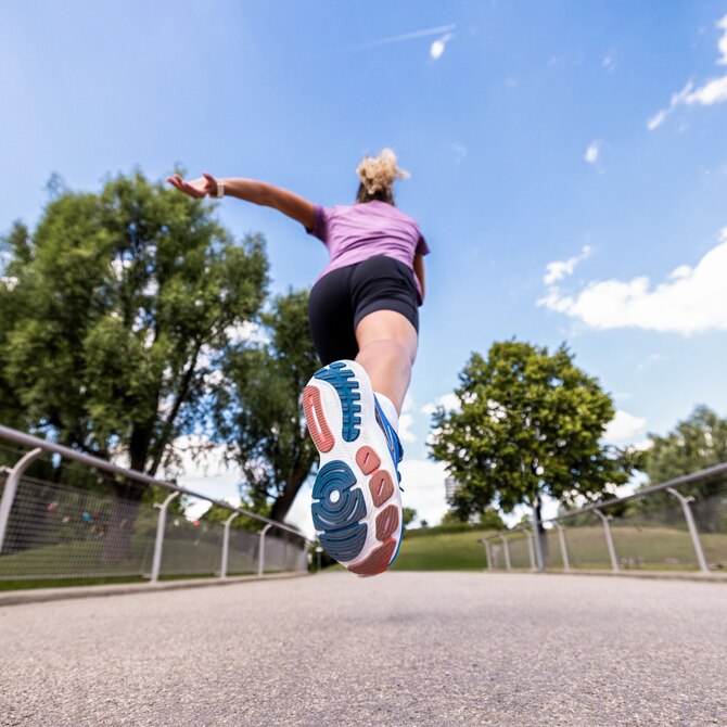 Long angle shot of a female runner running away