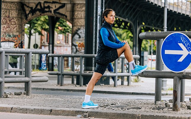 Runners performing dynamic exercises to warm up before running