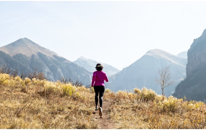 A woman running on trail