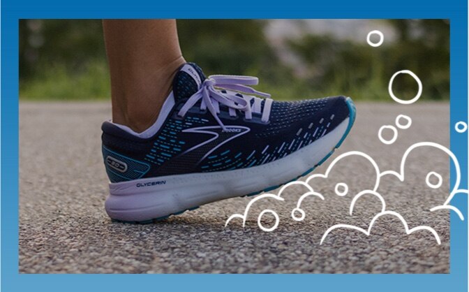Close-up of a foot wearing a Brooks running shoe surrounded by bubbles
