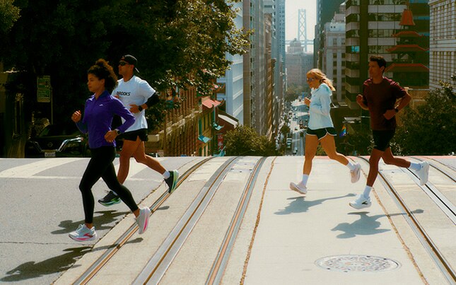 group of men and women running across the street in Brooks Glycerin Max 2 running shoes