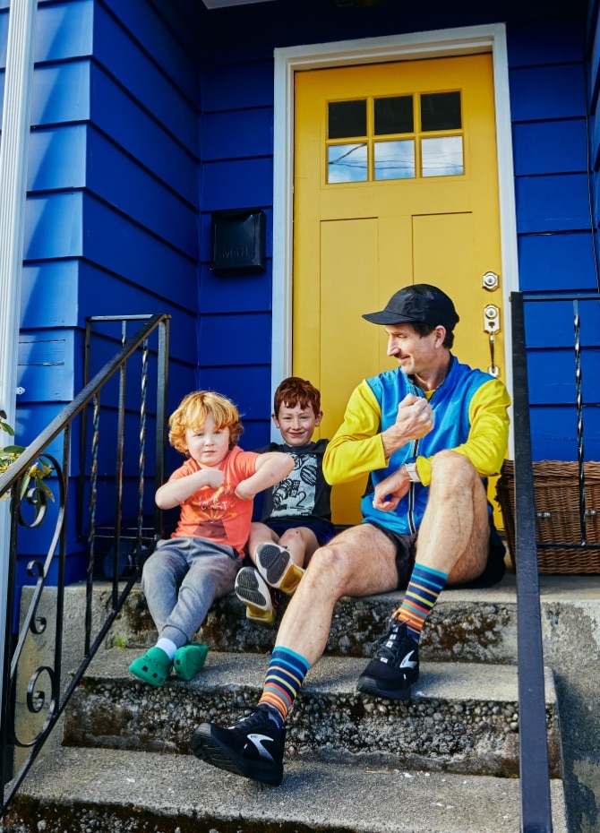 Ben sitting on stairs with his kids