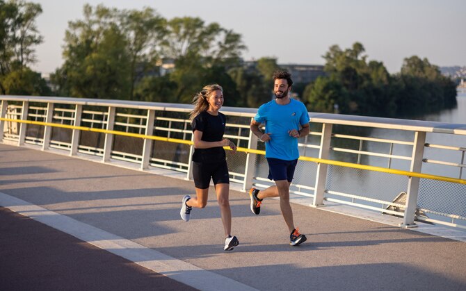 Two runners running together on a track