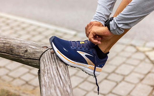 close up of someone wearing Brooks Adrenaline GTS 23 running shoes