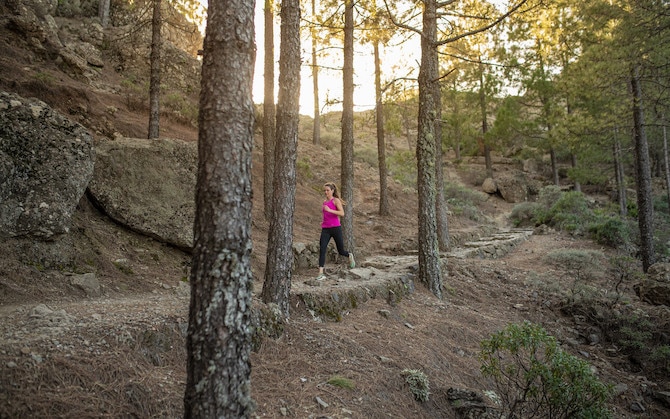 Woman running through a forest