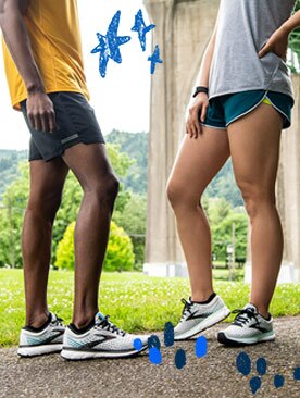A man and woman pose in running shorts and light, warm weather shirts.