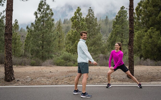 Deux coureurs faisant des étirements