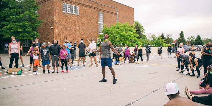 Prolyfyck run crew members chanting in the middle of a circle