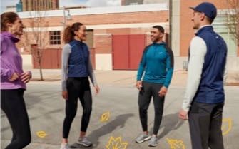 A group of runners in a circle chatting