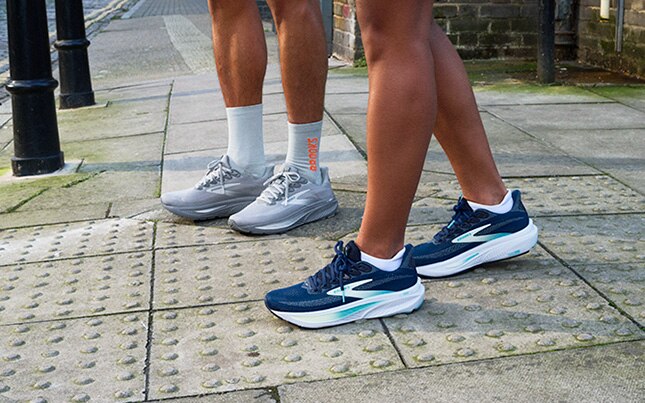 Close-up of two people’s feet wearing the Ghost 17 on the sidewalk