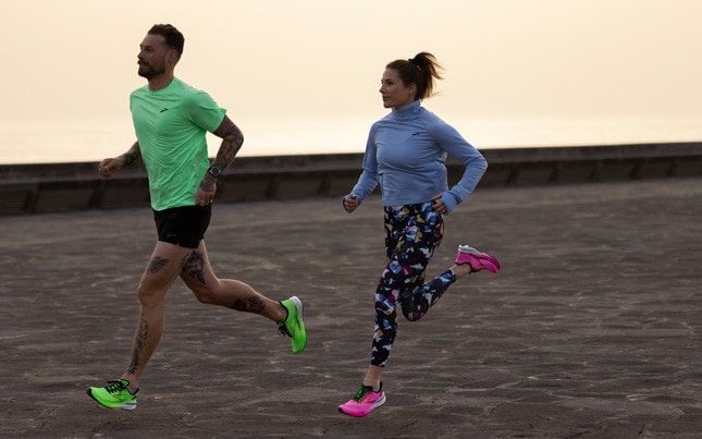 Close-up view of a runner wearing a pair of running shoes with arch support.
