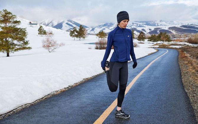 Runner holding her foot in a stretch