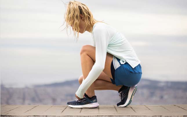 Two runners sit on the ground and recover after a marathon race.