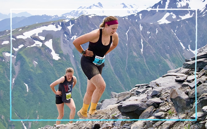 Two women walking up a mountain