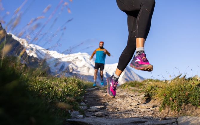 Two runners on a trail track