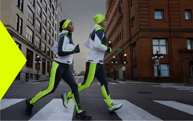 Twee hardlopers die in het donker hardlopen
